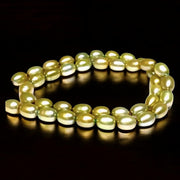 Smooth Oval 7 x 8.5mm Champagne Green Cultured FW Pearl 16" Strand